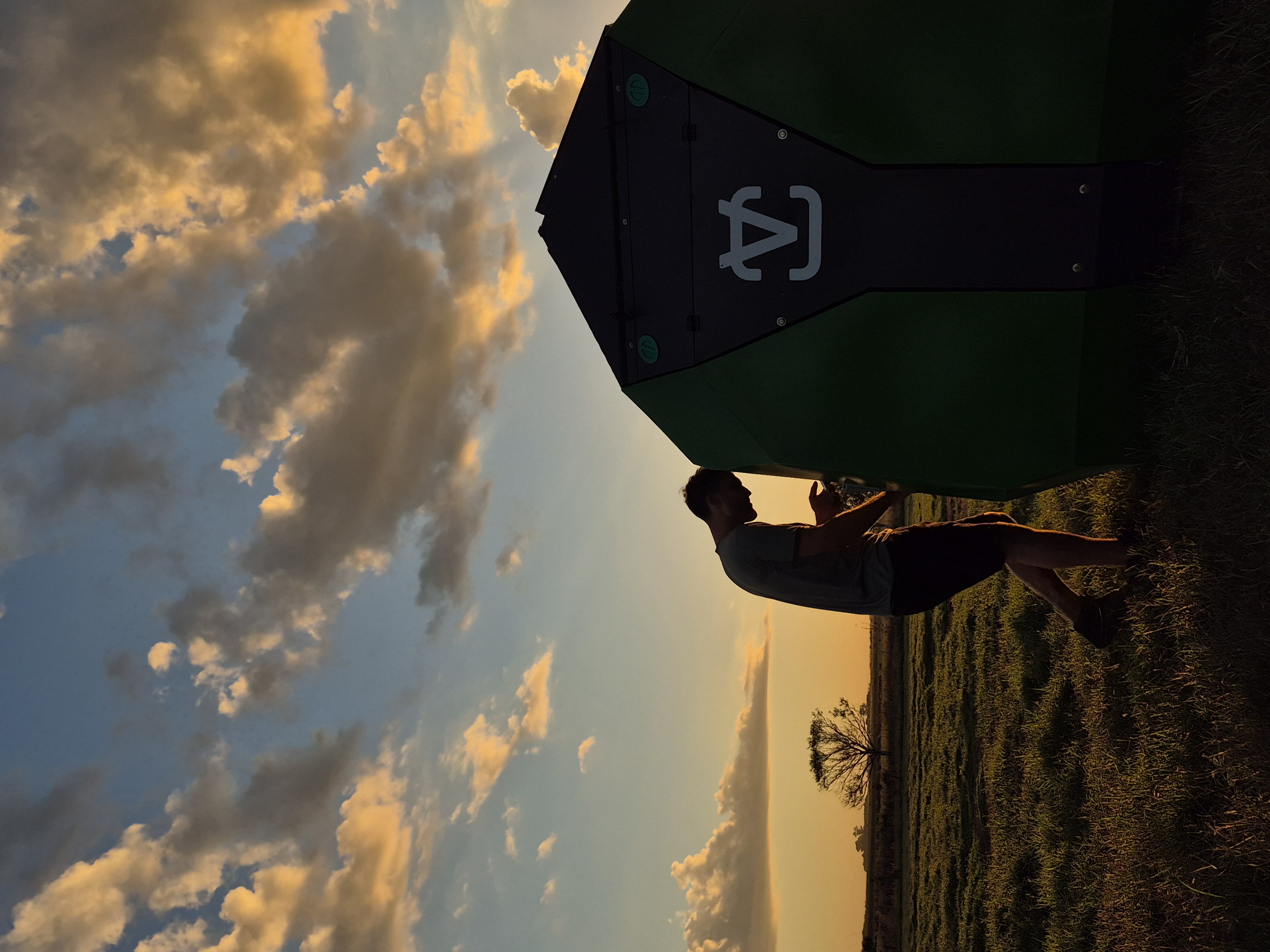 Technician servicing a Vetkiosk device at dusk